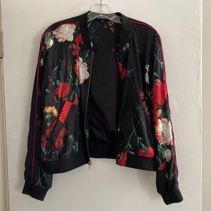 Black jacket with floral print. Medium weight with cropped waist feel.